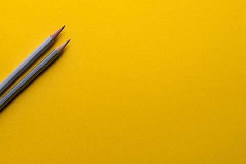 Yellow background with pencils